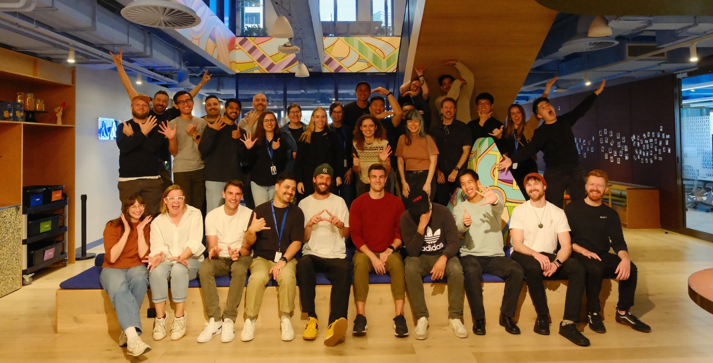 A large group of designers and engineers from the Atlassian Design team pose together at a group offsite.