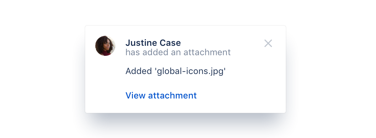 An example flag notifying the user that Justine Case has added the "global-icons.jpg" attachment. It has a call-to-action to "view attachment".