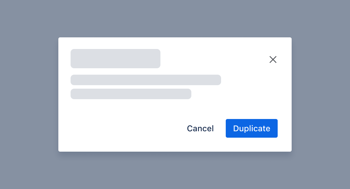 Two buttons in a group are correctly placed in the bottom-right corner of the modal. The first is a secondary subtle button without a border and says cancel. The second is a primary button, blue in color, and says duplicate.